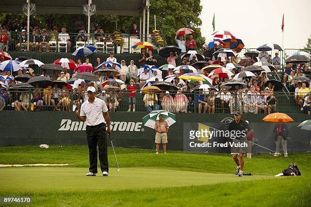 Bridgestone Invitational: Tiger Woods victorious after making birdie putt on No 18 during Saturday play at Firestone CC. Rain, weather. Akron, OH...