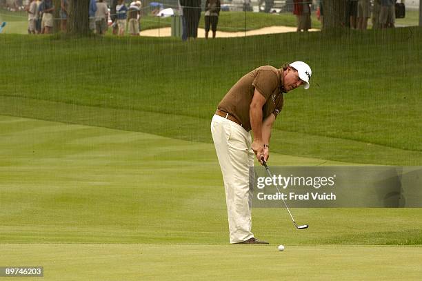 Bridgestone Invitational: Phil Mickelson in action, missing birdie putt on No 14 during Saturday play at Firestone CC. Rain, weather. Akron, OH...