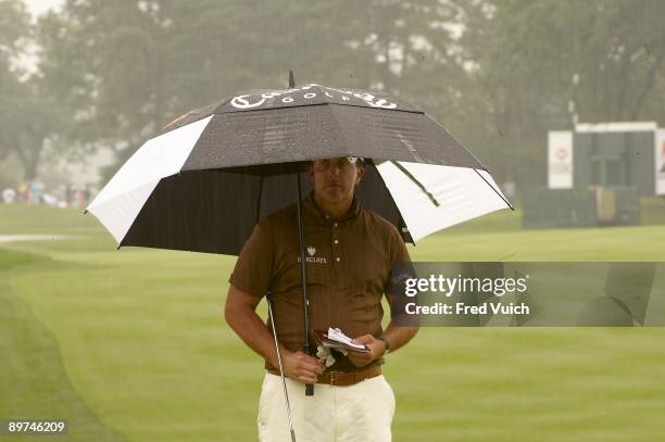 Bridgestone Invitational: Phil Mickelson holding umbrella during Saturday play at Firestone CC. Rain, weather. Akron, OH 8/8/2009 CREDIT: Fred Vuich