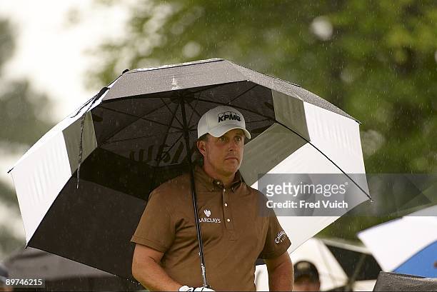 Bridgestone Invitational: Phil Mickelson holding umbrella during Saturday play at Firestone CC. Rain, weather. Akron, OH 8/8/2009 CREDIT: Fred Vuich