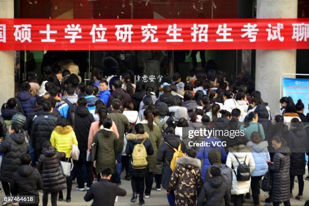Candidates queue up before sitting the National Postgraduate Entrance Examination at Liaocheng University examination hall on December 23, 2017 in...