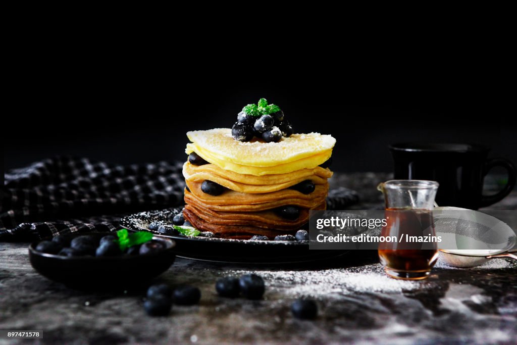 Putting sugar powder on Blueberry Pancake