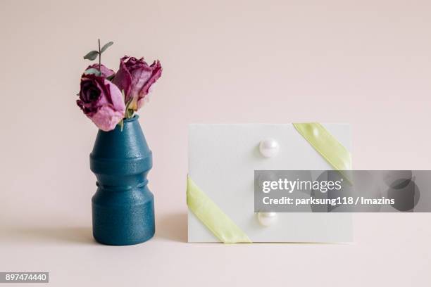 dry roses in a vas with invitation card - yoghurt pot stock pictures, royalty-free photos & images