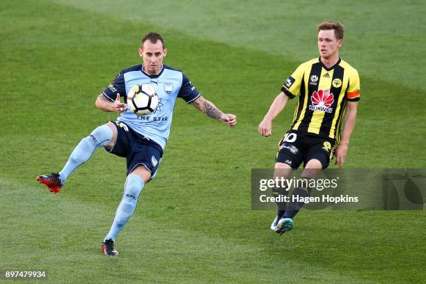 Luke Wilkshire of Sydney FC controls the ball under pressure from Michael McGlinchey of the Phoenix during the round 12 A-League match between the...