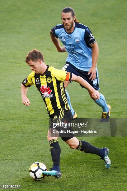 Michael McGlinchey of the Phoenix makes a break under pressure from Joshua Brillante of Sydney FC during the round 12 A-League match between the...