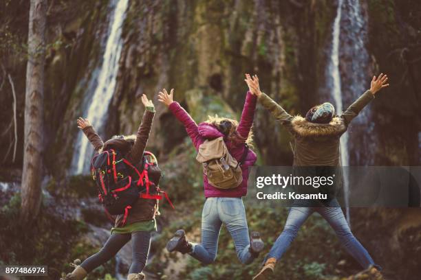 ecstatic adventurers - waterfall jump stock pictures, royalty-free photos & images