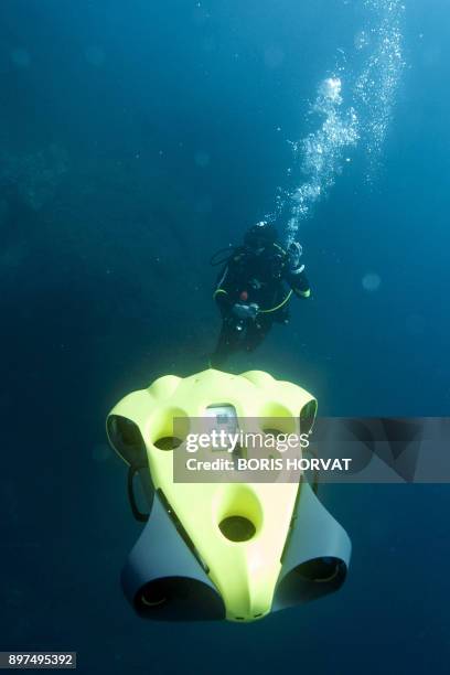 French diver Guillaume Nery uses the first submarine autonomous drone called "iBubble" on December 21, 2017 in order to run some tests during a...