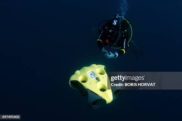 French diver Guillaume Nery uses the first submarine autonomous drone called "iBubble" on December 21, 2017 in order to run some tests during a...