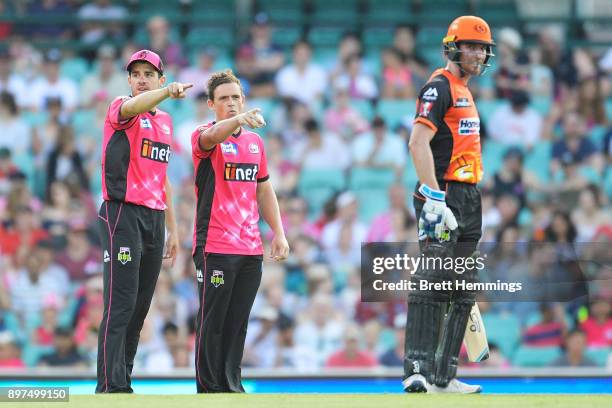 Moises Henriques of the Sixers directs players with Stephen O'Keefe of the Sixers during the Big Bash League match between the Sydney Sixers and the...