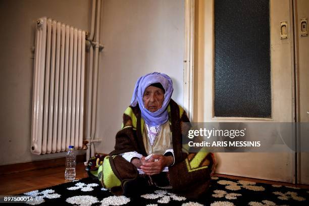 Laila Saleh, a 110 years old Syrian refugee from Kobane, poses for photographes, in Athens on December 15, 2017. Laila Saleh, who was born in Kobane...