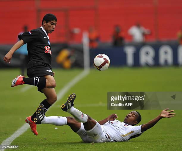 Paraguay's Libertad footballers Rodolfo Gamarra vies with Ecuador's Liga de Quito William Araujo, during their Copa Sudamericana football match, on...