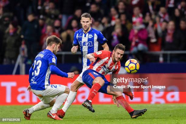 Jorge Koke of Atletico de Madrid attempts a kick while being defended by Alvaro Medran of Deportivo Alaves during the La Liga 2017-18 match between...