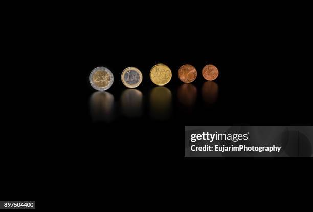 different types of euro coins isolated on black background - sparpaket stock-fotos und bilder