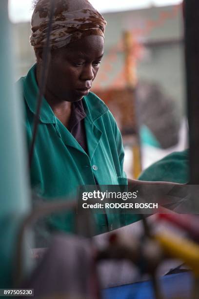 Worker at Kinross Clothing manufacturers in Maitland, sews men's trousers on October 19 in Cape Town. South Africa is fighting to revive its frayed...