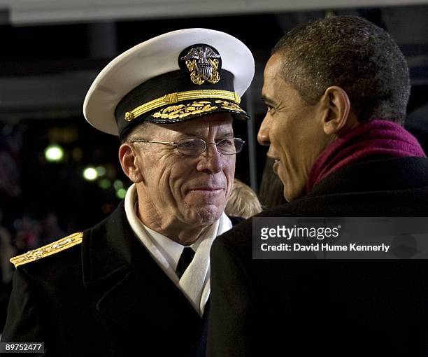 President Barack Obama and Chairman of the Joint Chiefs of Staff Mike Mullen speak during the inaugural parade in the reviewing stand along...