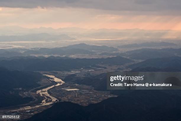 sunbeam on okayama city in okayama prefecture in japan sunset time aerial view from airplane - okayama stockfoto's en -beelden