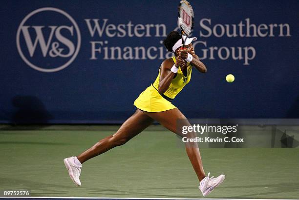 Venus Williams returns a shot to Olga Govortsova of Belarus during Day 2 of the Western & Southern Financial Group Women's Open on August 11, 2009 at...