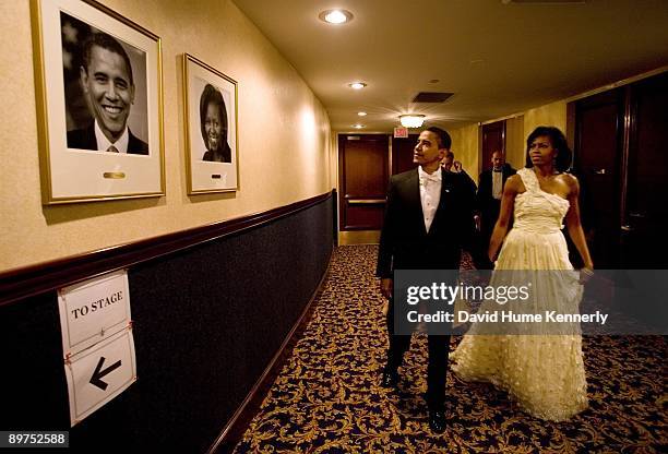 President Barack Obama and First Lady Michelle Obama look at their photos on the wall at the Hilton Washington prior to the MTV & ServiceNation: Live...