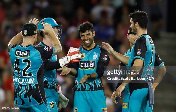 Shadab Khan of the Heat is congratulated by his teammates after dismissing Marcus Harris of the Renegades during the Big Bash League match between...