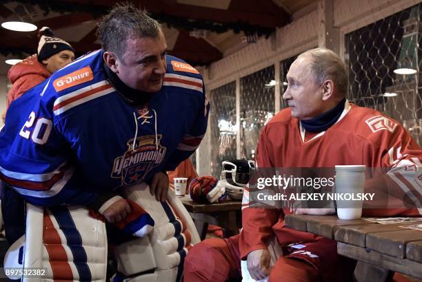 Russian President Vladimir Putin speaks with Governor of the Tula Region Alexei Dyumin during a ten minutes' break during the Night Hockey League...