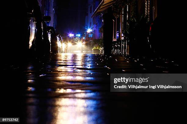 police car with flashing lights at night - police lights stock-fotos und bilder