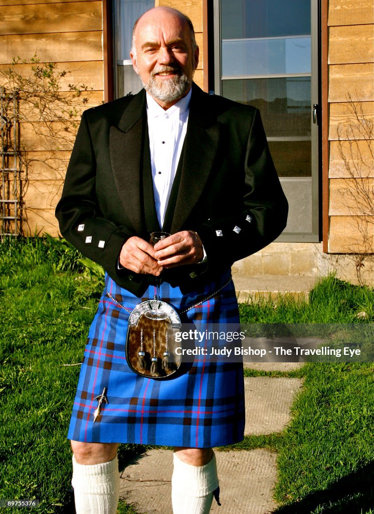 Elegant man in kilt, with champagne