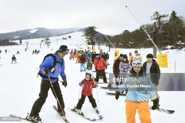 People ski and snowboard down a slope at Daisen White Resort in Daisen, Tottori Prefecture, western Japan, on Dec. 23, 2017. ==Kyodo