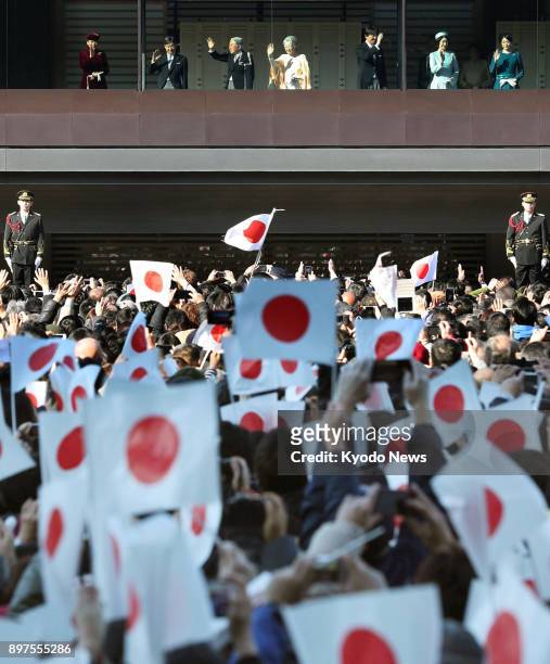 Japanese imperial family members wave to the crowd gathered to celebrate Emperor Akihito's 84th birthday at the Imperial Palace in Tokyo on Dec. 23,...