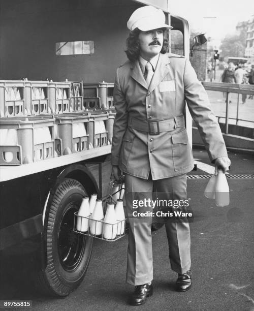 Milkman wearing the new prize-winning uniform, designed to make him more attractive to British housewives, circa 1972.