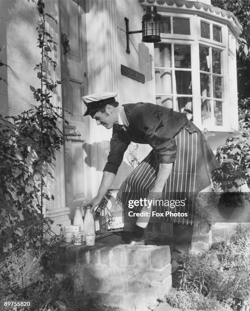 Milkman delivers dairy products to Pickenham House in London, February 1972.