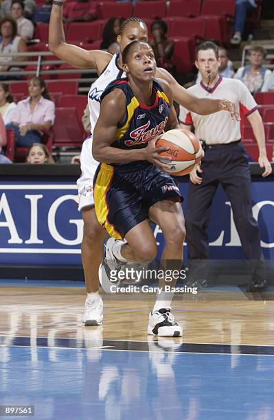 Nikki McCray of the Indiana Fever looks to the basket followed by Elaine Powell of the Orlando Miracle in the game on June 11, 2002 at TD Waterhouse...