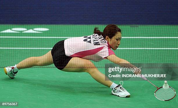 Ai Goto of Japan plays a shot against Mew Choo Wong of Malaysia during the women's singles second round badminton match of The World Badminton...