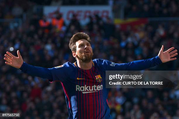 Barcelona's Argentinian forward Lionel Messi celebrates after scoring during the Spanish League "Clasico" football match Real Madrid CF vs FC...