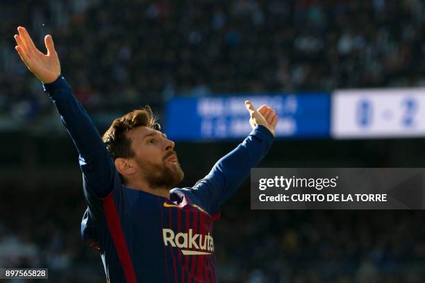 Barcelona's Argentinian forward Lionel Messi celebrates after scoring during the Spanish League "Clasico" football match Real Madrid CF vs FC...