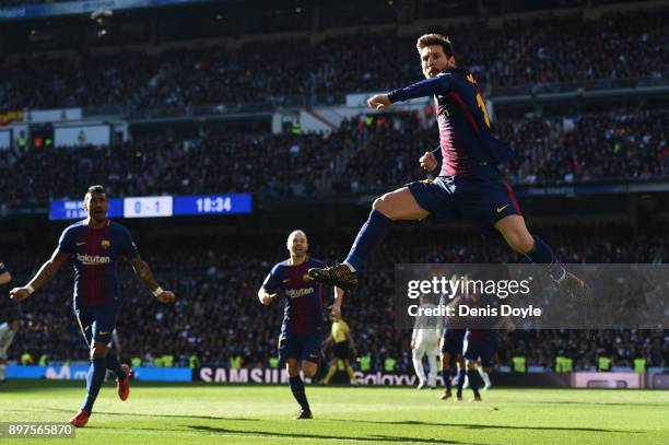Lionel Messi of Barcelona celebrates after scoring his sides second goal during the La Liga match between Real Madrid and Barcelona at Estadio...