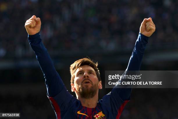 Barcelona's Argentinian forward Lionel Messi celebrates after scoring during the Spanish League "Clasico" football match Real Madrid CF vs FC...