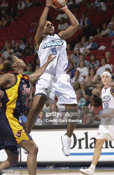 Elaine Powell of the Orlando Miracle puts up a shot over Nikki McCray of the Indiana Fever in the game on June 11, 2002 at TD Waterhouse Centre in...