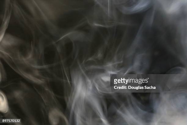 white smoke from a cigar on a black background - fetid stock pictures, royalty-free photos & images