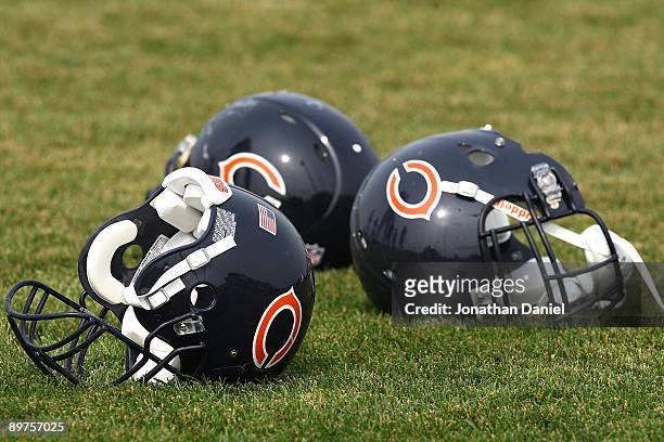 Three Chicago Bears helmuts rest on the field during a training camp practice on August 4, 2009 at Olivet Nazarene University in Bourbonnais,...