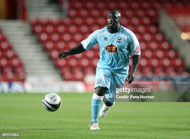 Adebayo Akinfenwa of Northampton Town runs with the ball during the Carling Cup Round One Match between Southampton and Northampton Town at St Mary's...