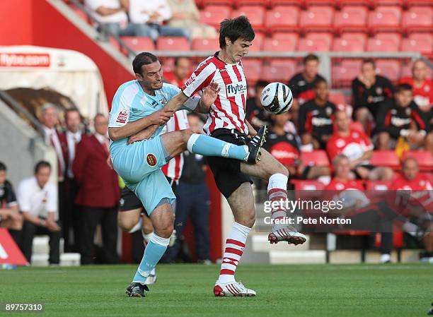 Matt Paterson of Southampton attempts to control the ball under pressure from Chris McCready of Northampton Town during the Carling Cup Round One...