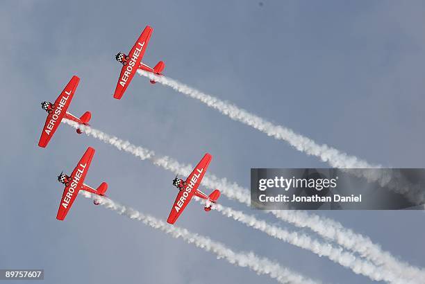 The AeroShell aerobatic team, flying pre-World War II AT-6 training planes, performs during the Experimental Aircraft Association's 2009 AirVenture...
