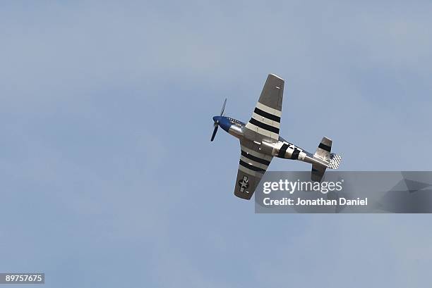 World War II-era P-51 Mustang flys during the Experimental Aircraft Association's 2009 AirVenture annual fly-in and convention on July 28, 2009 in...