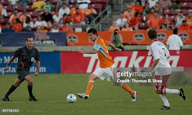 Bobby Boswell of the Houston Dynamo dribbles the ball against logan Pause of the Chicago Fire at Robertson Stadium on August 9, 2009 in Houston,...