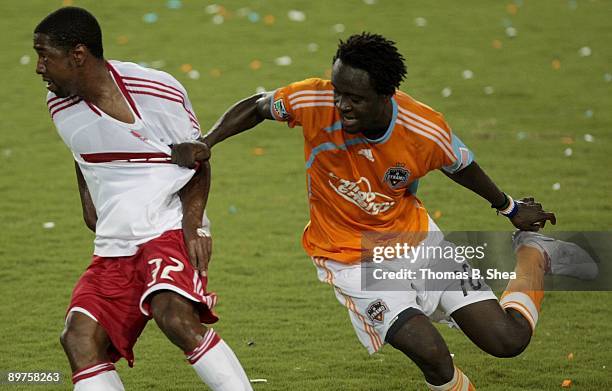 Kei Kamara of the Houston Dynamo is grabs the shirt of Dasan Robinson of the Chicago Fire at Robertson Stadium on August 9, 2009 in Houston, Texas.