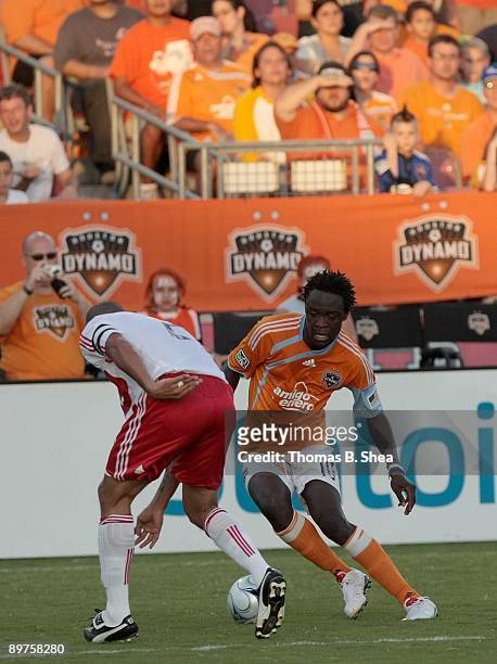 Kei Kamara of the Houston Dynamo dribbles the ball against C.J. Brown of the Chicago Fire at Robertson Stadium on August 9, 2009 in Houston, Texas.