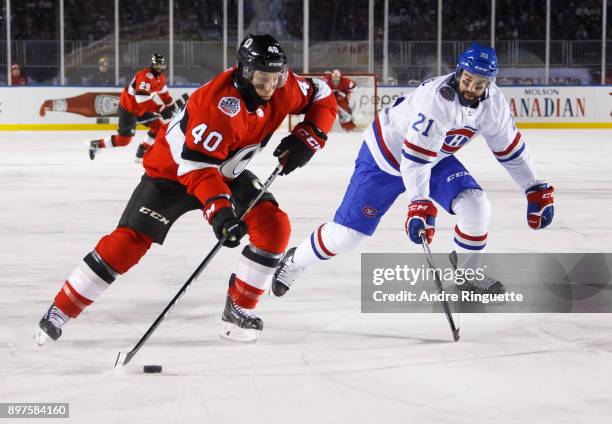 Gabriel Dumont of the Ottawa Senators skates against David Schlemko of the Montreal Canadiens in the 2017 Scotiabank NHL100 Classic at Lansdowne Park...