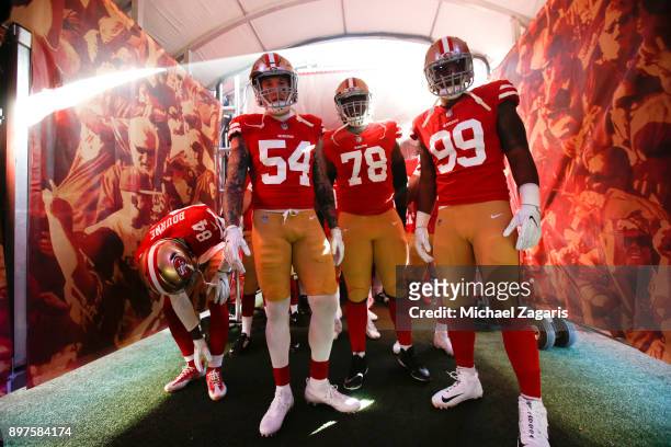 Cassius Marsh, Darrell Williams Jr. #78 and DeForest Buckner of the San Francisco 49ers get ready to take the field prior to the game against the...