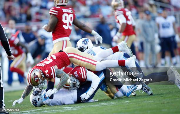 Reuben Foster and Cassius Marsh of the San Francisco 49ers pressure Marcus Mariota of the Tennessee Titans during the game at Levi's Stadium on...