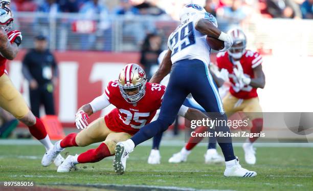 Eric Reid of the San Francisco 49ers tackles DeMarco Murray of the Tennessee Titans during the game at Levi's Stadium on December 17, 2017 in Santa...